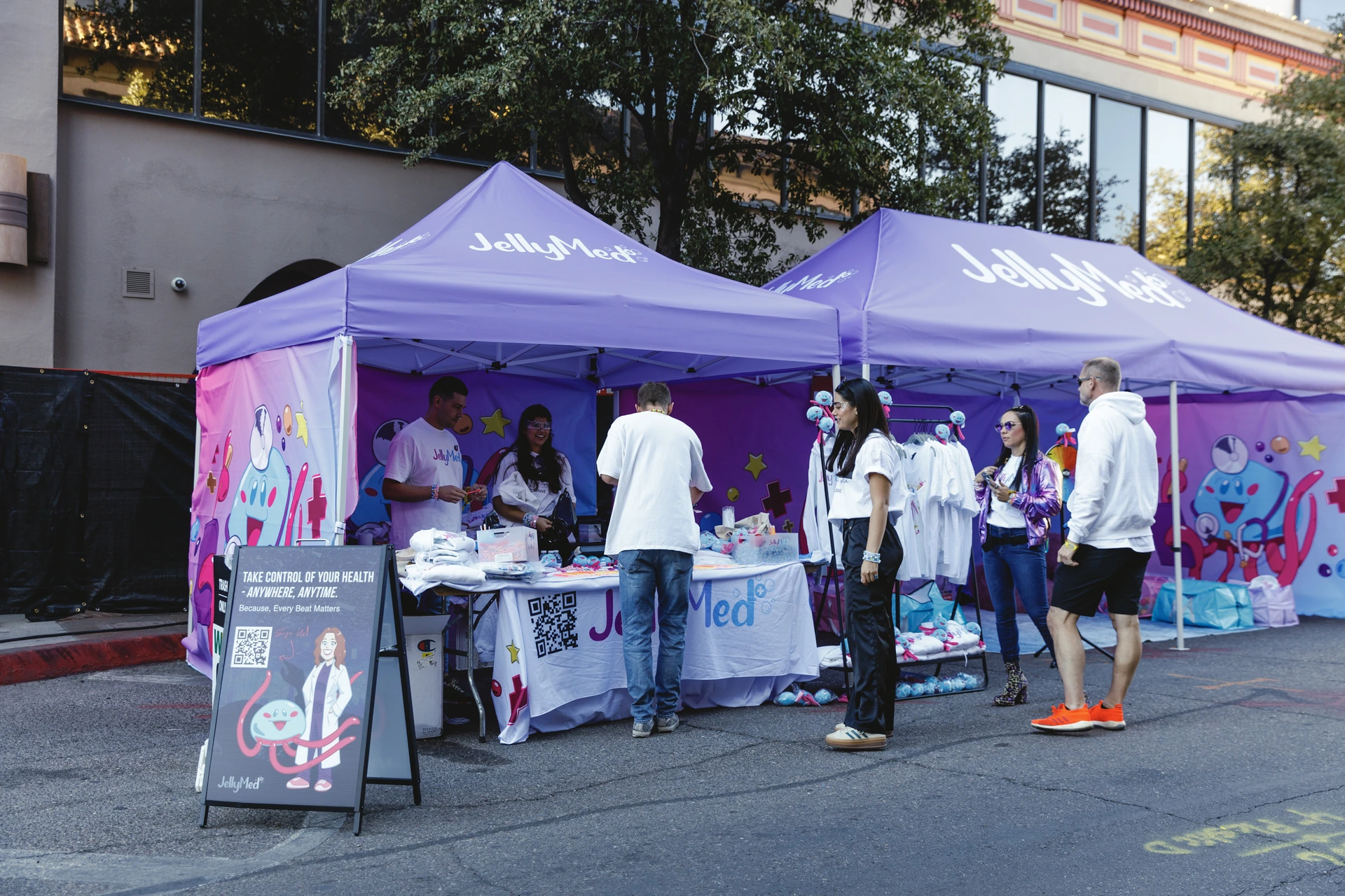 Guests stopping at the purple JellyMed tents at DUSK