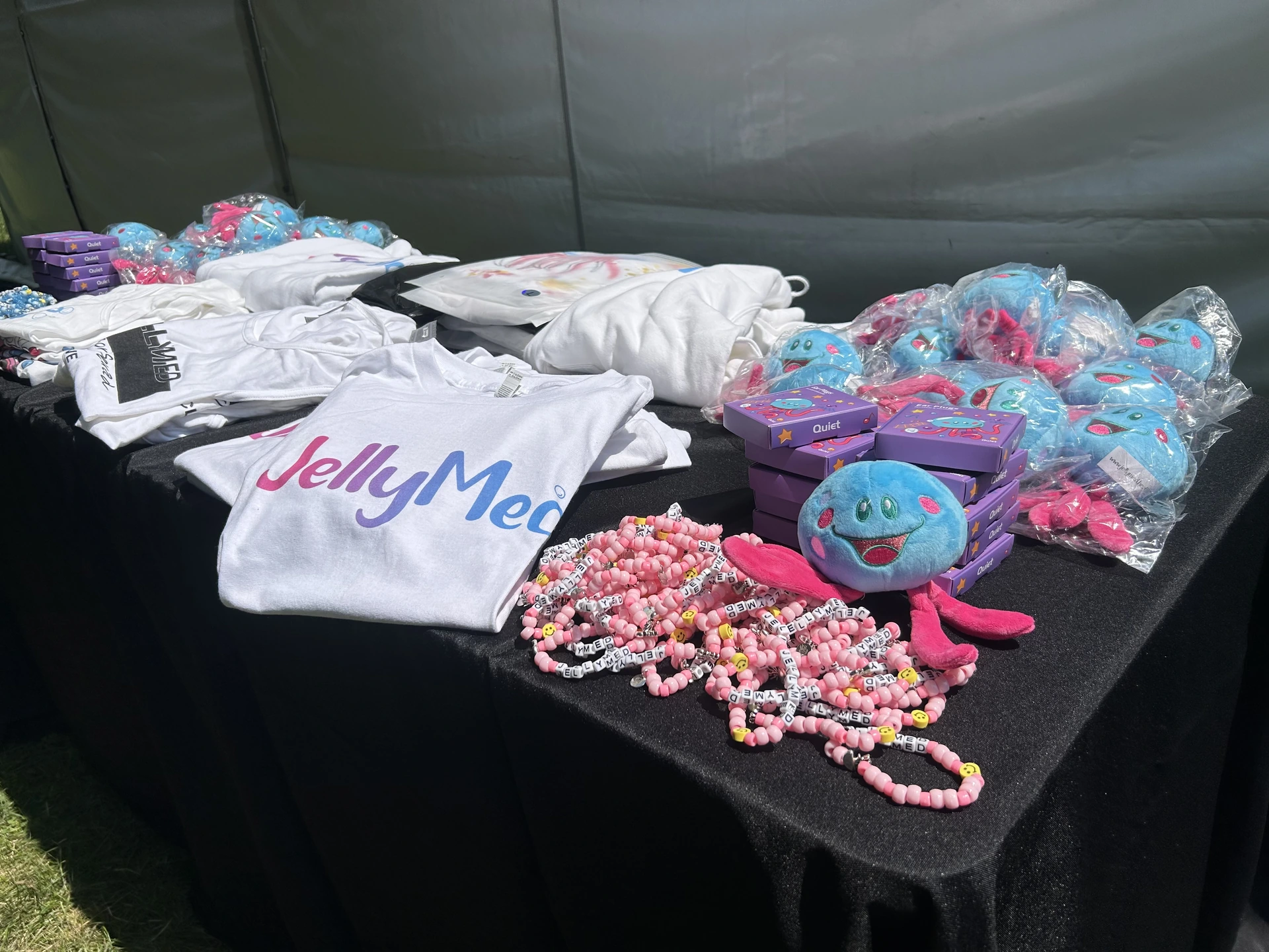 JellyMed shirts, blue Rori plushes, and colorful kandi bracelets at an event